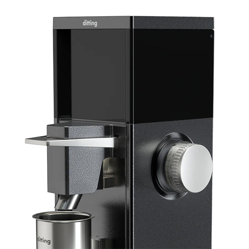 Black coffee grinder with a silver spout and knob on a white background