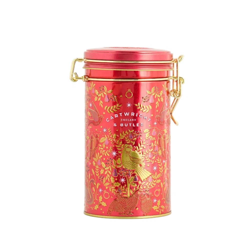 Red tin canister with gold accents on a white background