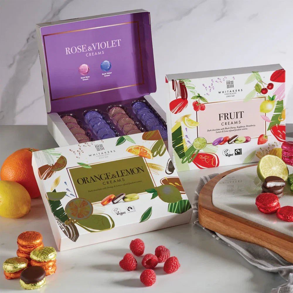 Assorted cream boxes with colorful packaging on a marble surface.