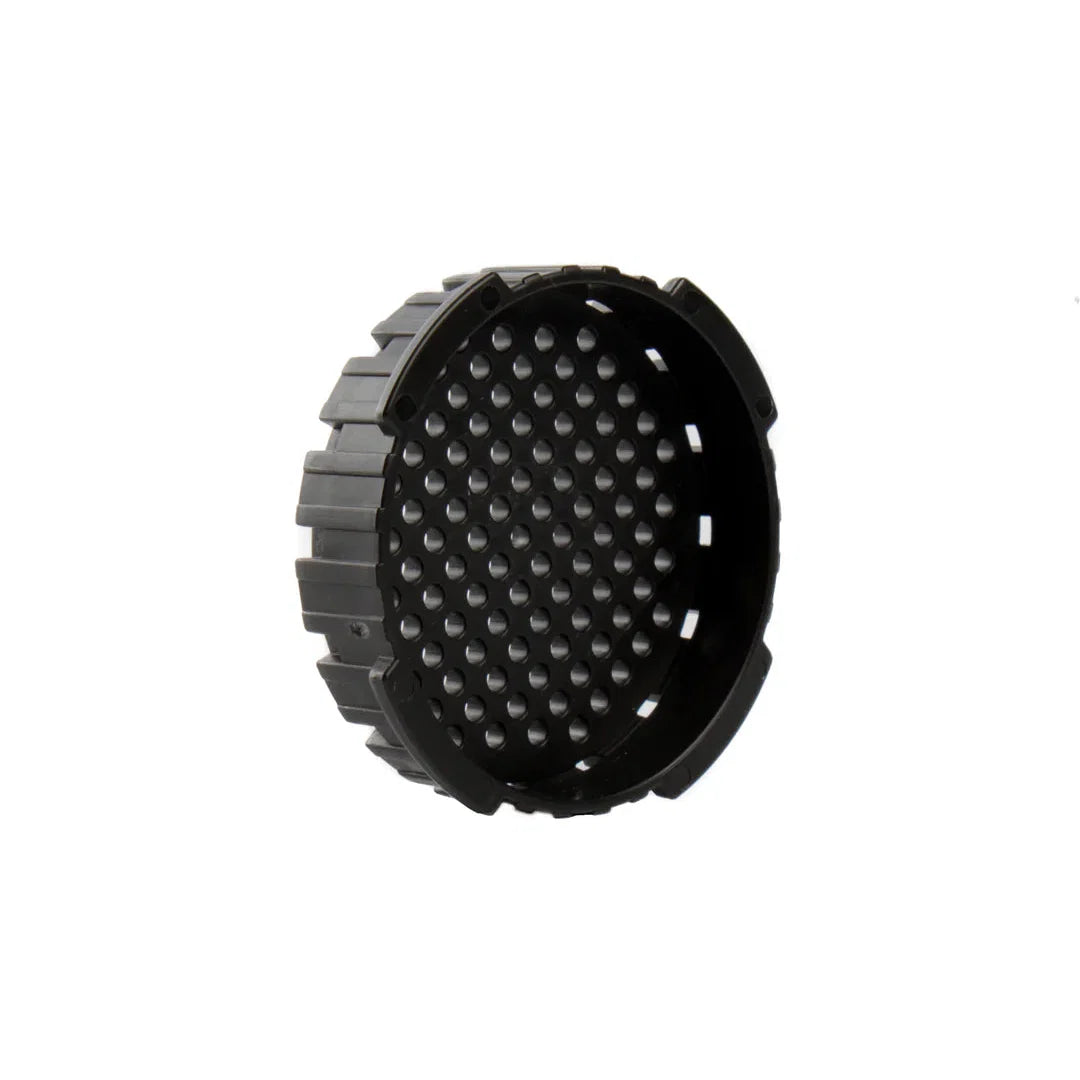 Black circular object with textured surface on a white background