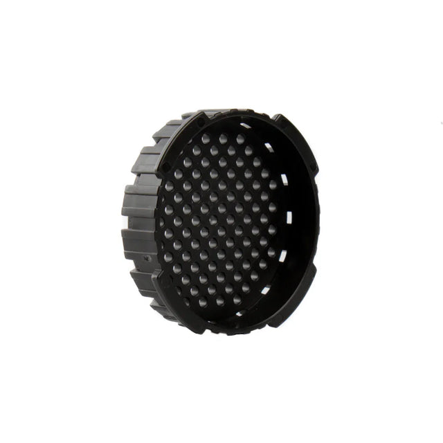 Black circular object with textured surface on a white background