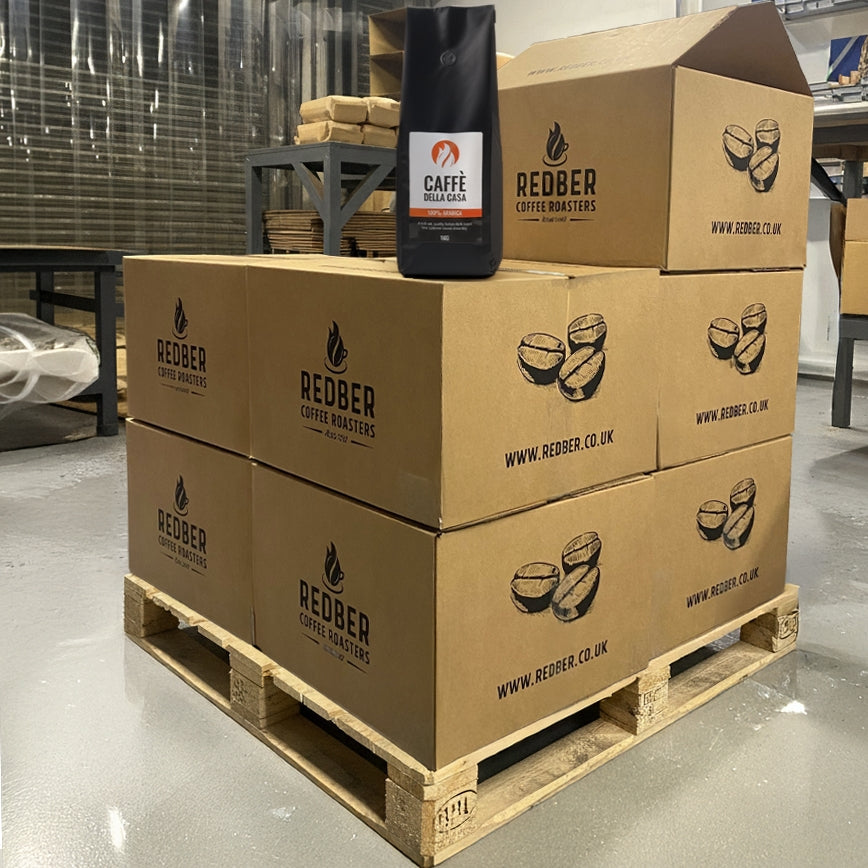 Stack of cardboard boxes with Redber Coffee Roasters branding in a warehouse setting.