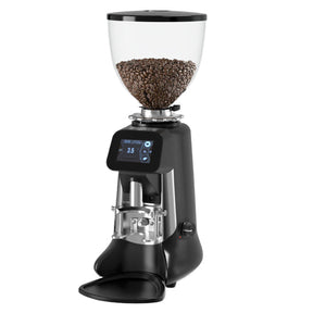 Black coffee grinder with glass container of coffee beans on a white background