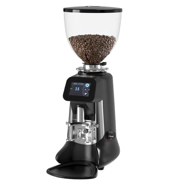 Black coffee grinder with glass container of coffee beans on a white background