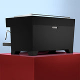 Black coffee machine on a red platform with a light blue background