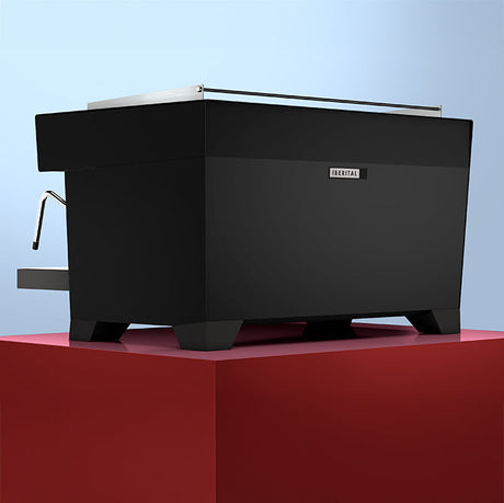 Black coffee machine on a red platform with a light blue background
