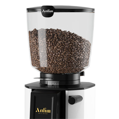 Coffee grinder filled with coffee beans on a white background
