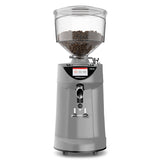 Coffee grinder with clear container filled with coffee beans on a white background
