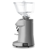 Silver coffee grinder with clear top on a white background
