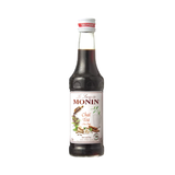 Bottle of Monin Chai Tea syrup on a white background
