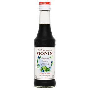 Bottle of Monin Blueberry Matcha Green Tea syrup on a white background