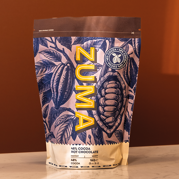 Zuma hot chocolate packaging with leaf design on a brown background