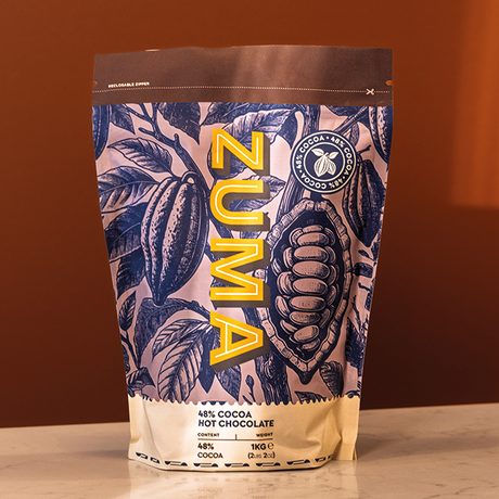 Zuma hot chocolate packaging with leaf design on a brown background