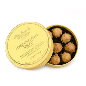 Gold tin of Lemon Cheesecake Truffles with visible brand name on a white background
