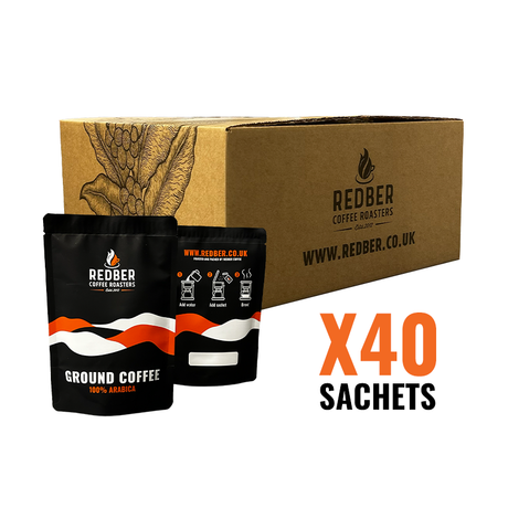 Redber Coffee Roasters packaging with two coffee sachets and a cardboard box on a white background.